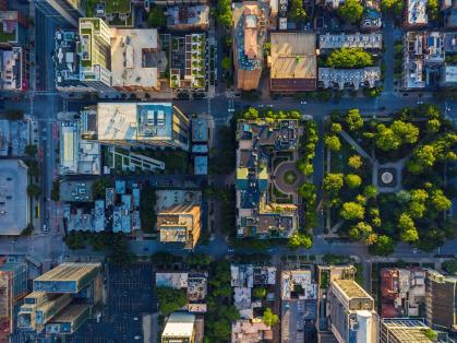 Aerial view of city with parks interspersed